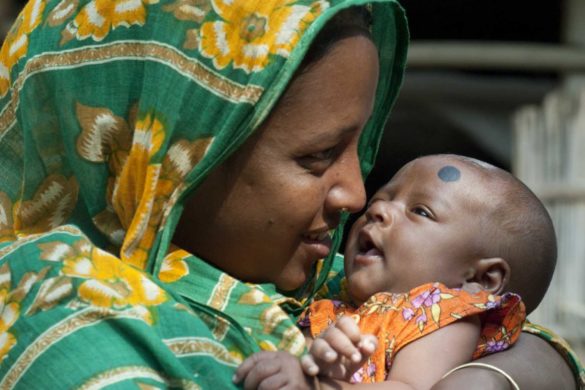 Layly, 26, and her child posed for photograph while they come for vaccination at Tarapur Saner Chor, Astadhor Union, Mymensingh, Bangladesh on 21 December 2009. Bangladesh Government runs immunization project in Mymensingh supported by UNICEF.