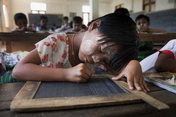 Su Latt Wai (8) a class three student is writing on slate in her classroom in Puzunchaung Primary School, Kungyangone, Yangon Region, Burma on 8 February 2012. Her father is a fisherman and most of the fisherman in this area was lost there boat and net for fishing by cyclone NARGIS in 2008. Fishermen’s are got support from Oxfam Novib by support Metta foundation for new boat and fishing net.  Now they are stable in daily life and sending there children’s to school for educating.