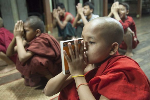 Little monks are praying in Kungyangone Monastery on 8 February 2012 at Kungyangone, Yangon Region, Burma. Kungyangone Monastery was play vital role for saving peoples live in NARGIS 2008