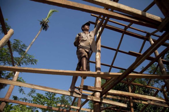 Myat Tun (45) a fisherman is building his home in Ka Zin Chaung village, Bogale, Delta on 9 February 2012 Bogale, Yangon Region, Burma. Most of the fisherman in this area was lost there boat and net for fishing by cyclone NARGIS in 2008. Fishermen’s are got financial support from Oxfam Novib for new boat and fishing net.