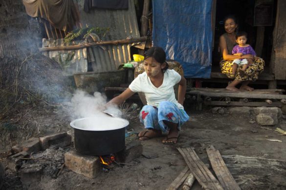 Aye (14) is cooking in font of home in Paung Ta Chaung village on 10 February 2012, Bogale, Yangon Region, Burma.